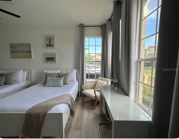 a bedroom with a bed and a large window