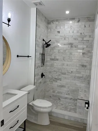 a bathroom with a toilet and a shower
