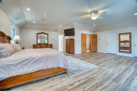a view of a bedroom with wooden floor