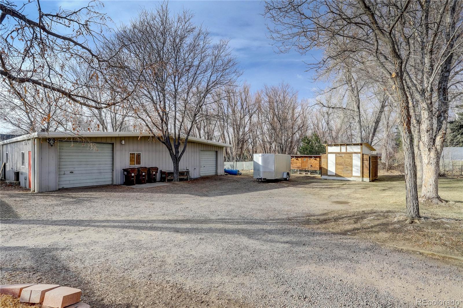 933 Cherryvale Road Boulder, CO 80303 - Photo 28 of 32 a white house that has a tree on the side of it
