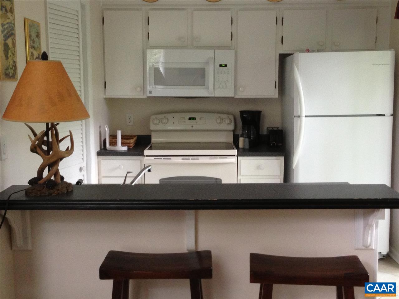 459 Three Ridges, Unit 459 Roseland, VA 22967 - Photo 6 of 11 a kitchen with a sink a table and chairs