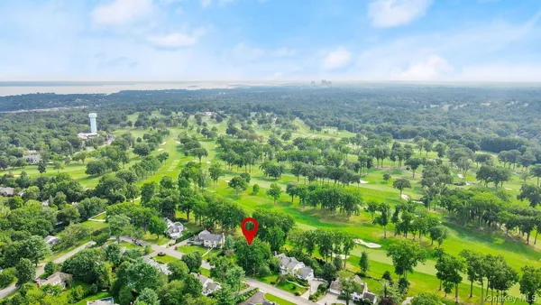 an aerial view of residential house with green space