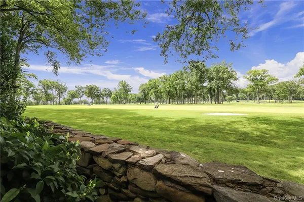 a view of a golf course with an ocean