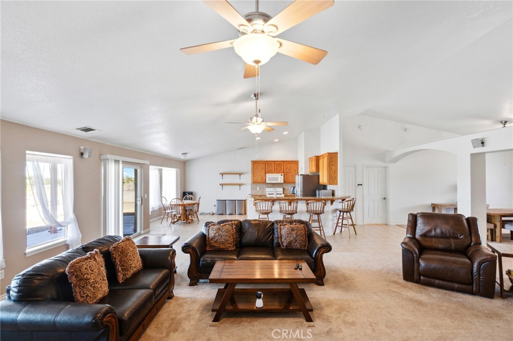 11025 El Esteban Road Phelan, CA 92371 - Photo 12 of 54 a living room with furniture a large window and a chandelier