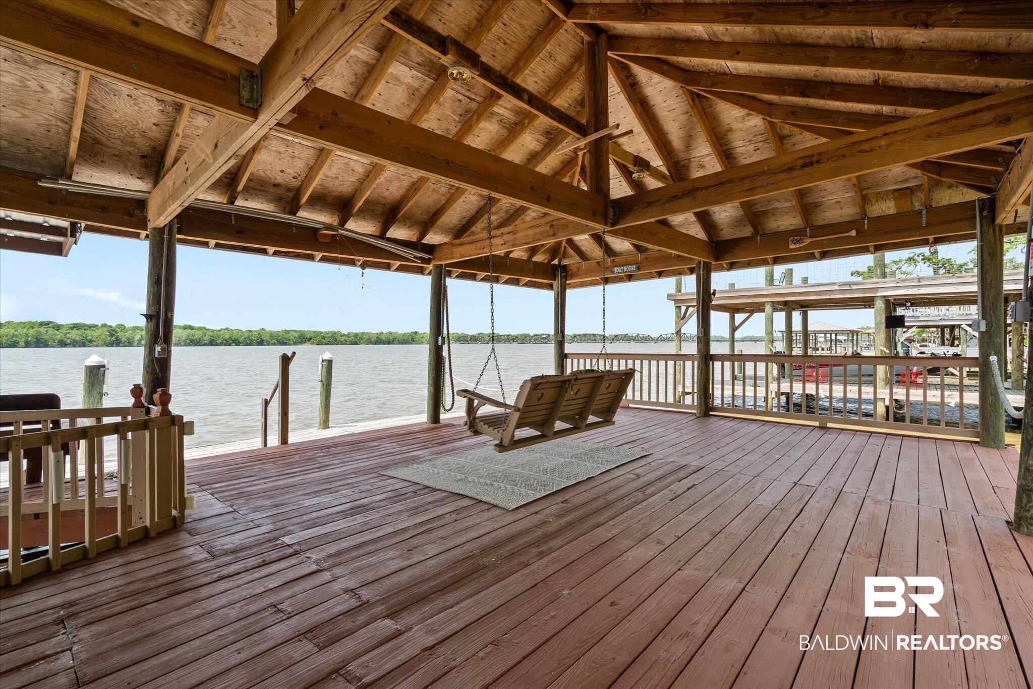 41923 Bayou Road Bay Minette, AL 36507 - Photo 28 of 35 Expansive covered dock featuring wood decking, exposed wood beam ceiling, and water access