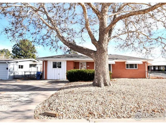 a view of a house with a yard covered in snow