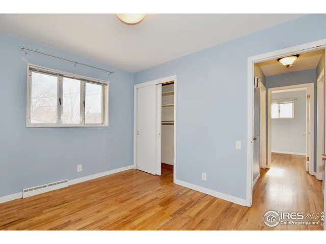 a view of an empty room and wooden floor
