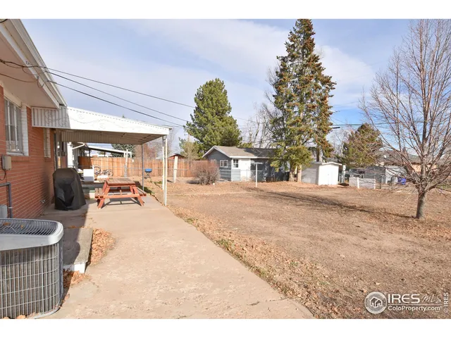 a view of a house with a yard covered in snow