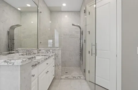 a bathroom with a shower sink and mirror