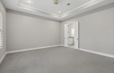 an empty room with white wall and a window