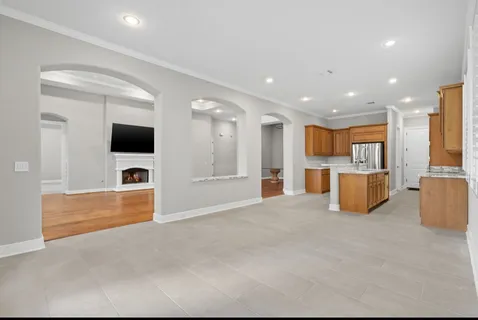 a view of kitchen with stainless steel appliances kitchen island sink and refrigerator
