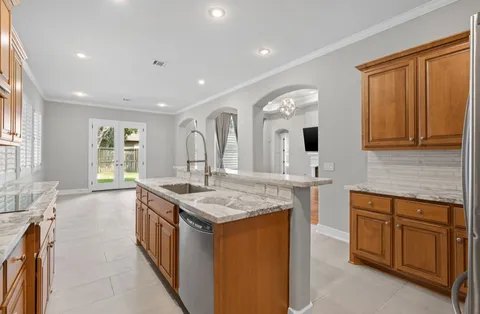a kitchen with a sink stove and cabinets