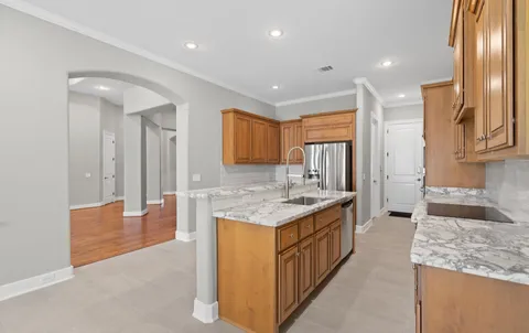 a kitchen with stainless steel appliances granite countertop cabinets and wooden floor