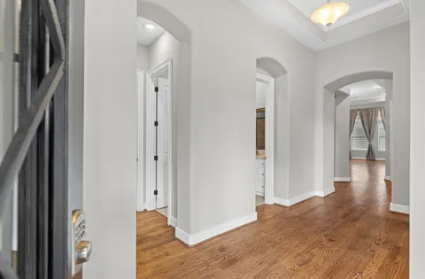 a view of a hallway with wooden floor