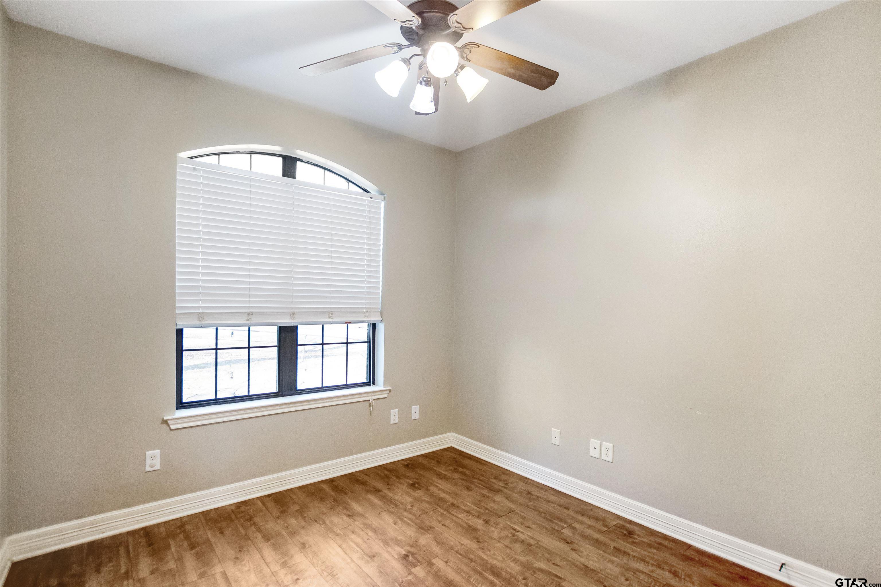 1687 West Point Road Kilgore, TX 75662 - Photo 12 of 41 a view of an empty room with window and chandelier fan