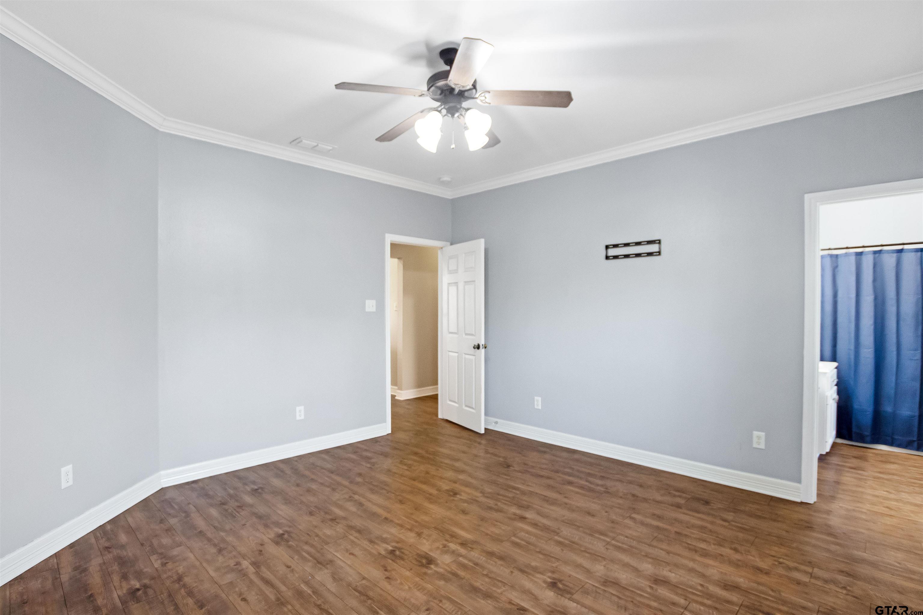 1687 West Point Road Kilgore, TX 75662 - Photo 14 of 41 a view of an empty room with wooden floor