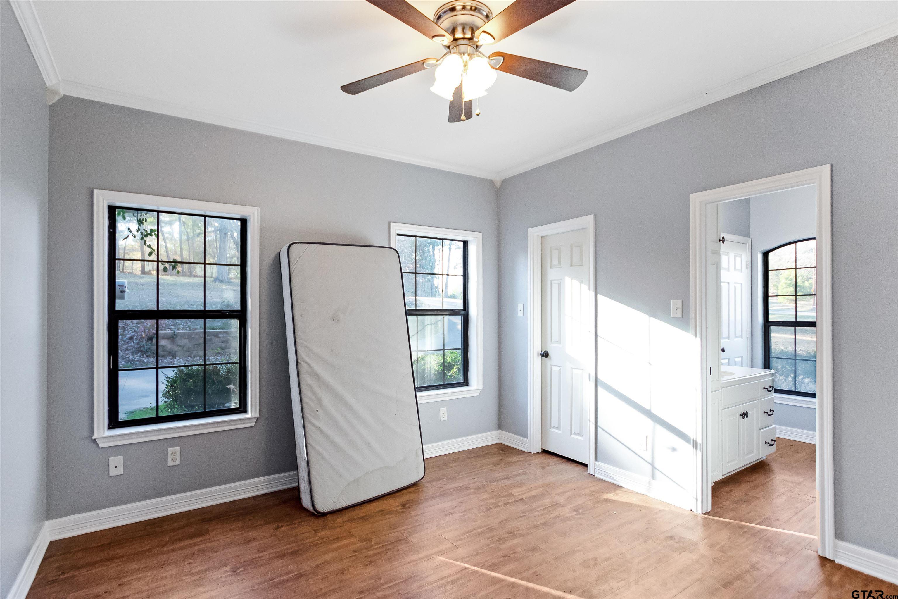 1687 West Point Road Kilgore, TX 75662 - Photo 21 of 41 a view of a bedroom with closet and windows