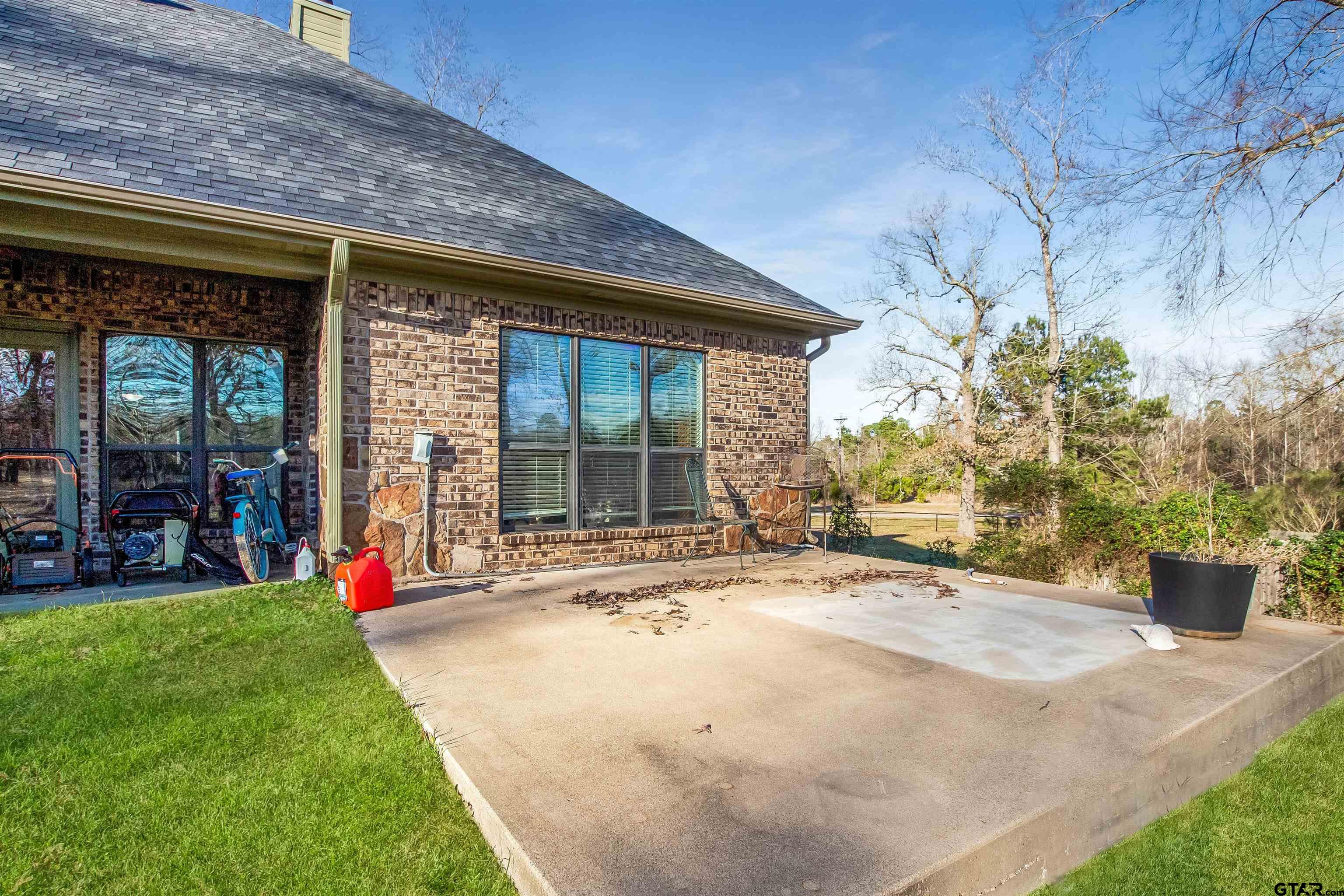 1687 West Point Road Kilgore, TX 75662 - Photo 36 of 41 a view of a backyard with potted plants and a fountain