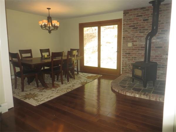 30 Holmes Road Boxford, MA 01921 - Photo 8 of 30 a dining room with wooden floor a chandelier a glass table and chairs