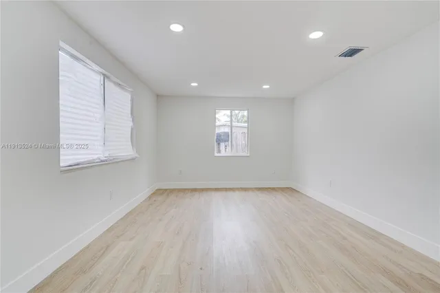 a view of a kitchen cabinets and a wooden floor