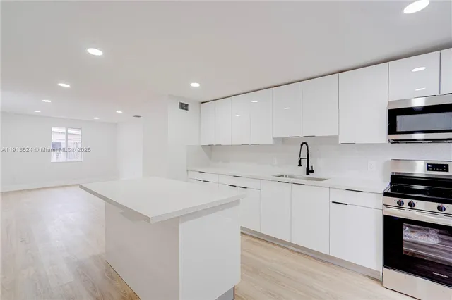 a kitchen with a sink and cabinets