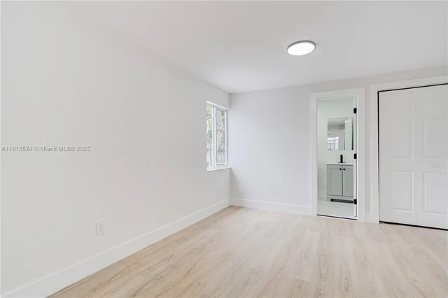 a view of a room with wooden floor