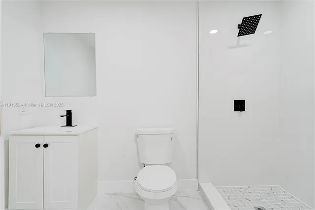 an aerial view of residential houses with outdoor space and trees