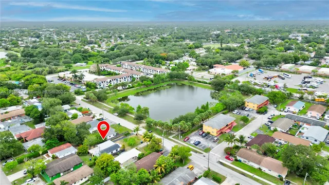 an aerial view of a house with yard