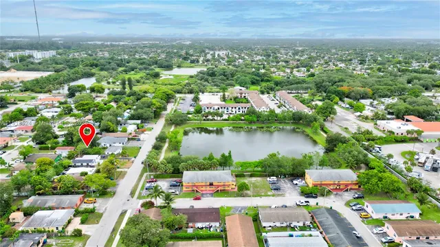 an aerial view of a house with yard