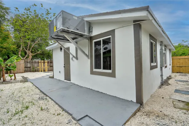 a view of a house with a snow in the background