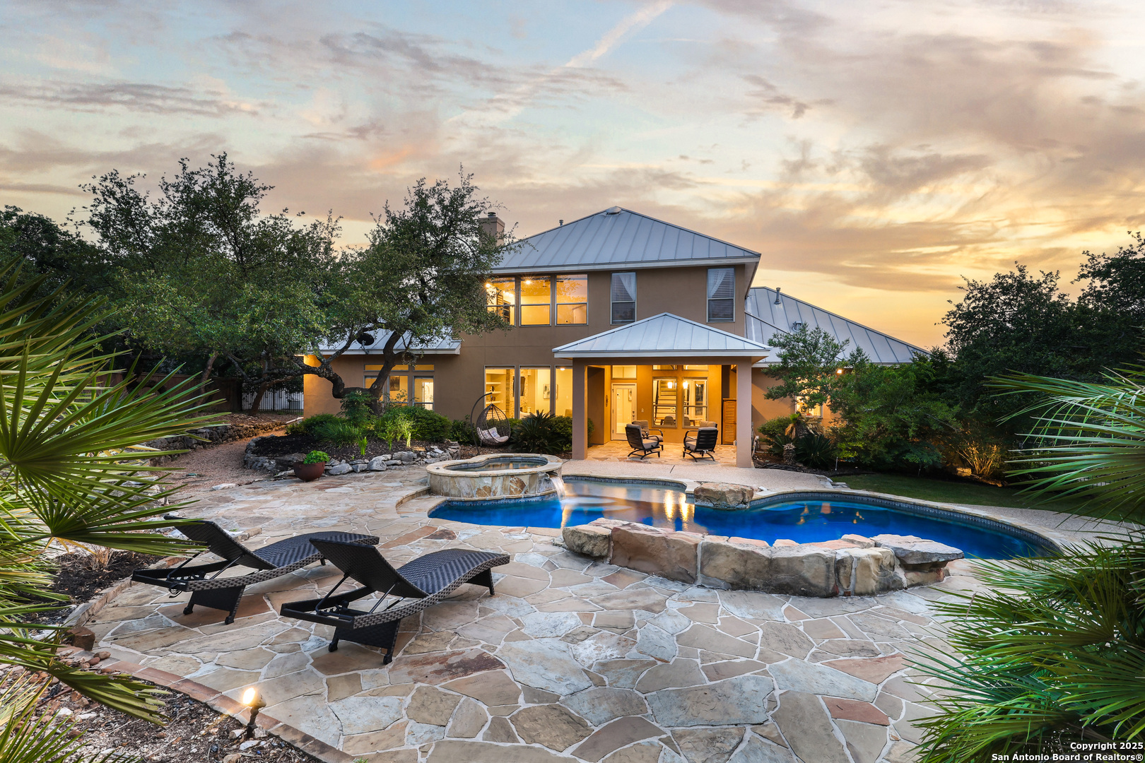 a view of a house with swimming pool and sitting area