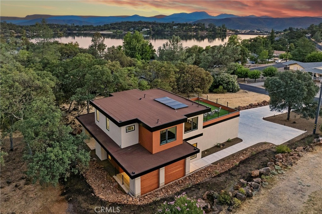 an aerial view of a house with a yard
