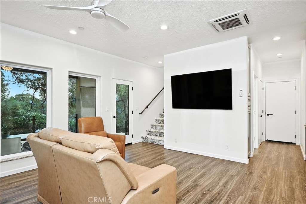 17234 Brookfield Road Hidden Valley Lake, CA 95467 - Photo 21 of 35 a living room with furniture tv and a floor to ceiling window