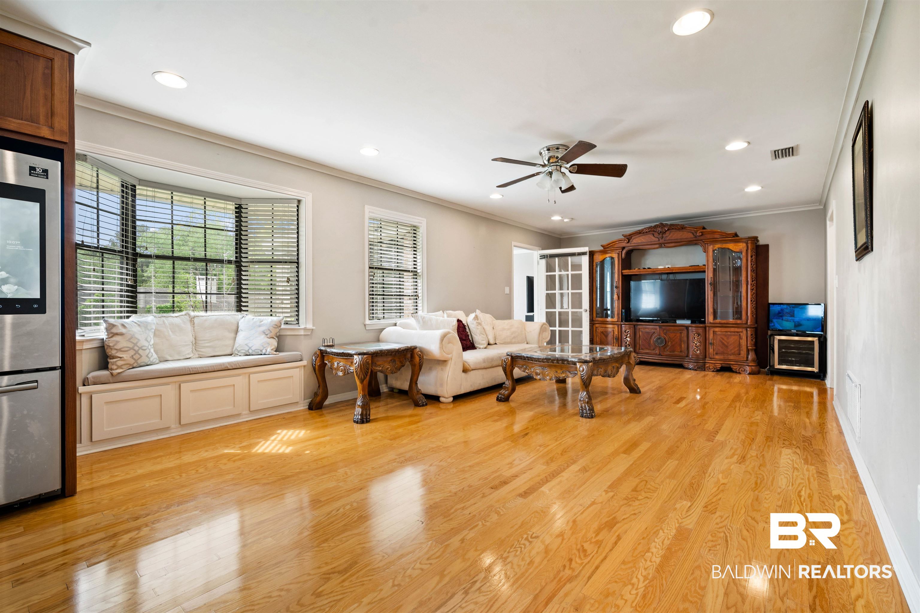 627 Spanish Main Spanish Fort, AL 36527 - Photo 6 of 39 Living room featuring ceiling fan, ornamental molding, light wood finished floors, and visible vents
