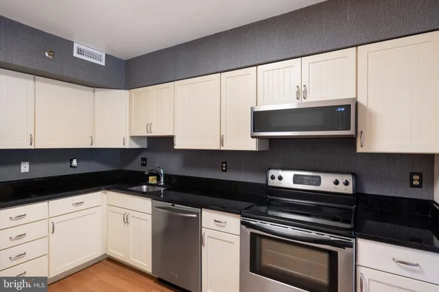 a kitchen with a sink a stove and refrigerator