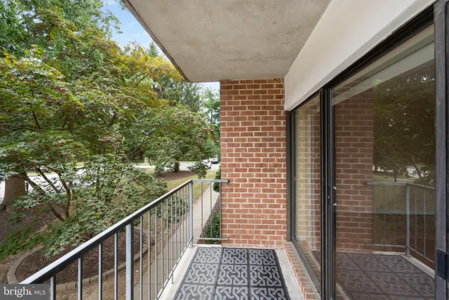 a bathroom with a granite countertop bathtub shower sink vanity mirror and toilet