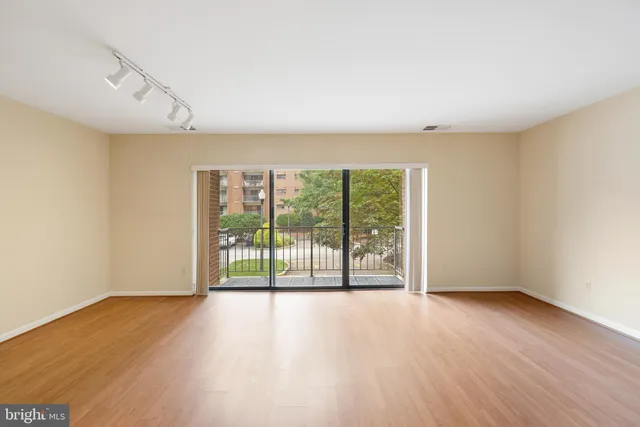a view of an empty room with glass door