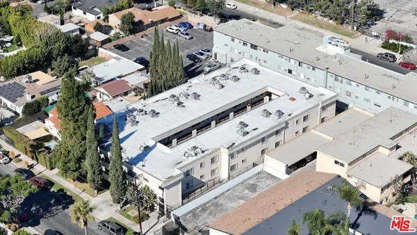 an aerial view of a building with an outdoor space