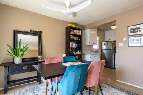 a view of a dining room with furniture and a potted plant