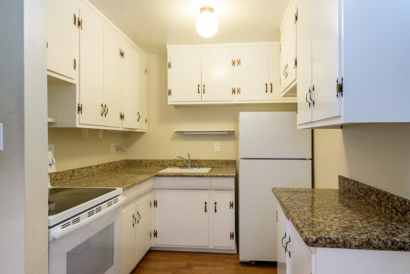 1437 Floribunda Avenue Burlingame, CA 94010 - Photo 22 of 35 a kitchen with granite countertop a sink a stove and cabinets