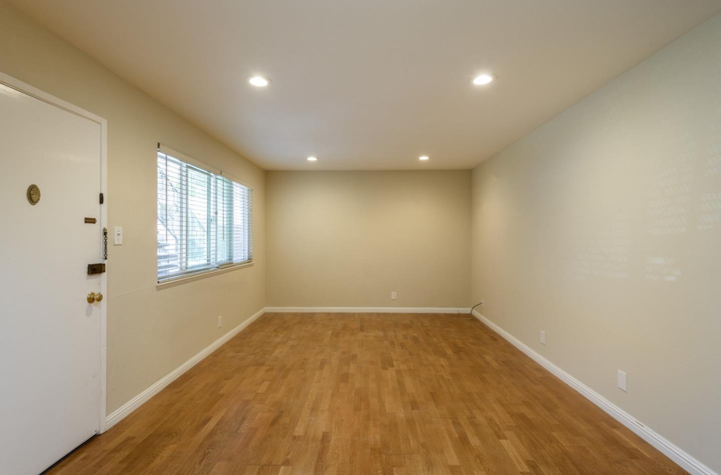 1437 Floribunda Avenue Burlingame, CA 94010 - Photo 23 of 35 an empty room with wooden floor and windows