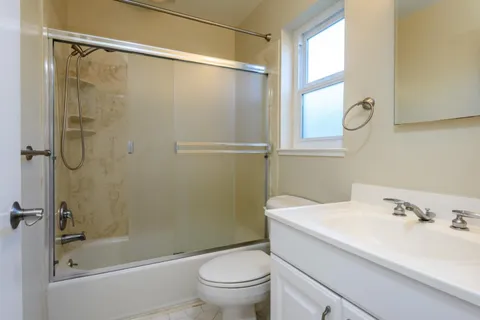 a bathroom with a sink toilet and shower