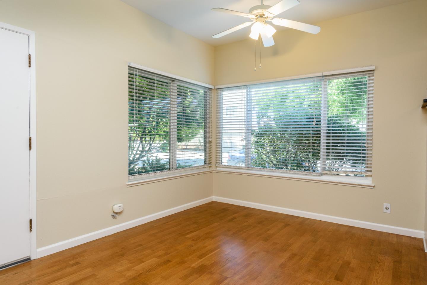 1437 Floribunda Avenue Burlingame, CA 94010 - Photo 26 of 35 a view of an empty room with wooden floor and a window