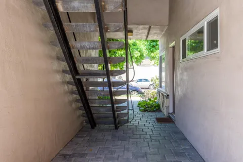 a view of balcony with wooden floor