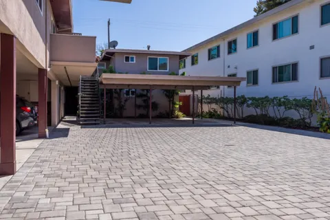 a front view of a building with a yard