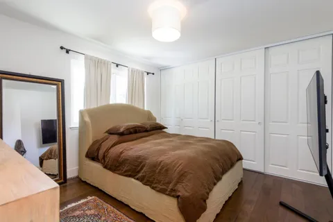 a bedroom with a bed and a large mirror