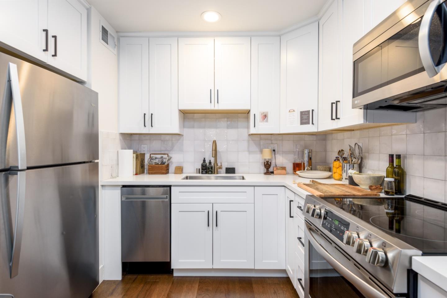 1437 Floribunda Avenue Burlingame, CA 94010 - Photo 10 of 35 a kitchen with a sink a refrigerator and cabinets