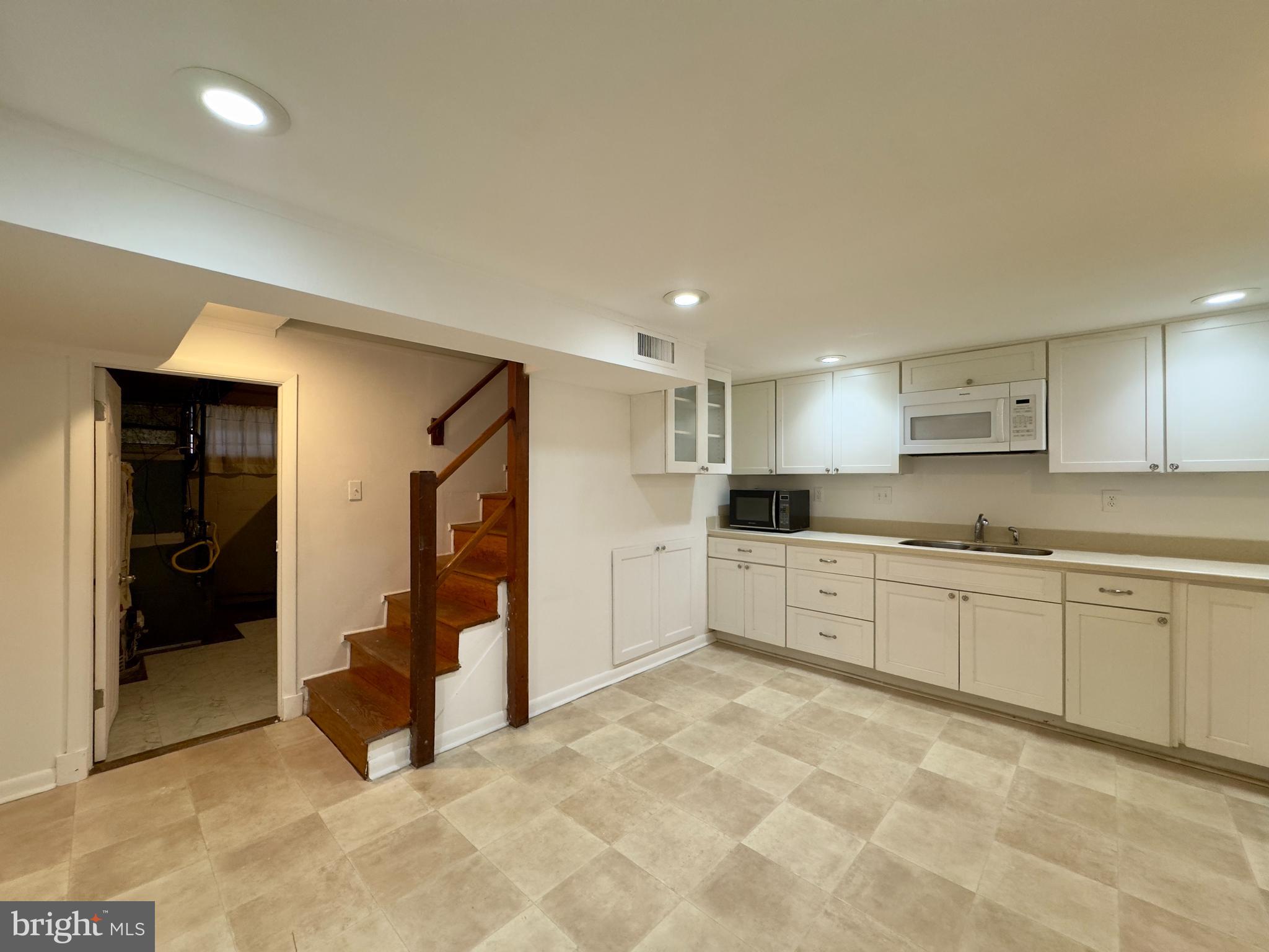 712 Bethnal Road Baltimore, MD 21229 - Photo 7 of 20 a large kitchen with stainless steel appliances granite countertop a refrigerator and a stove top oven