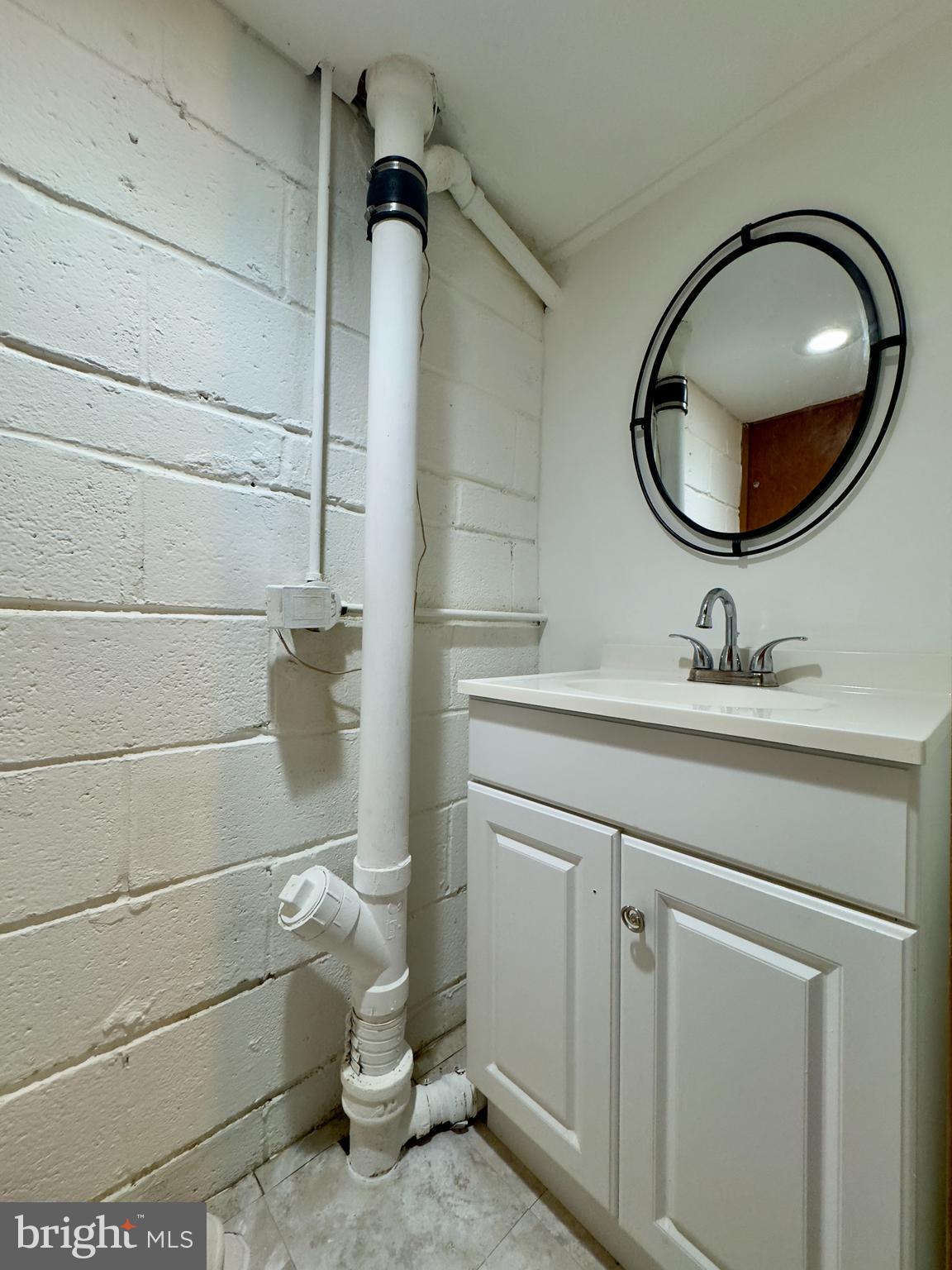 712 Bethnal Road Baltimore, MD 21229 - Photo 9 of 20 a bathroom with a sink mirror and toilet