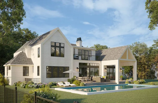 a front view of a house with swimming pool and chairs